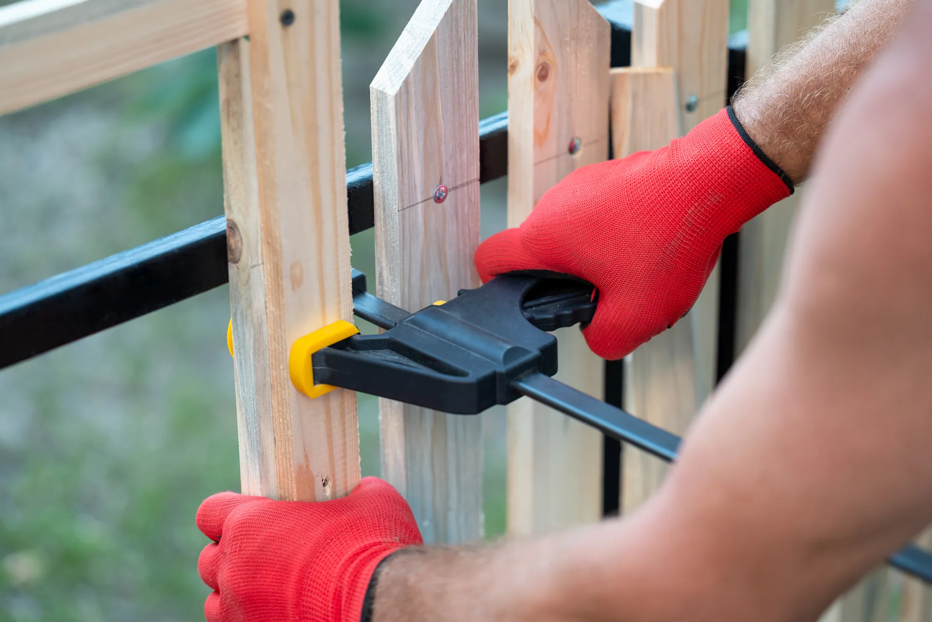 Close up bar clamp wood picket fence assembly