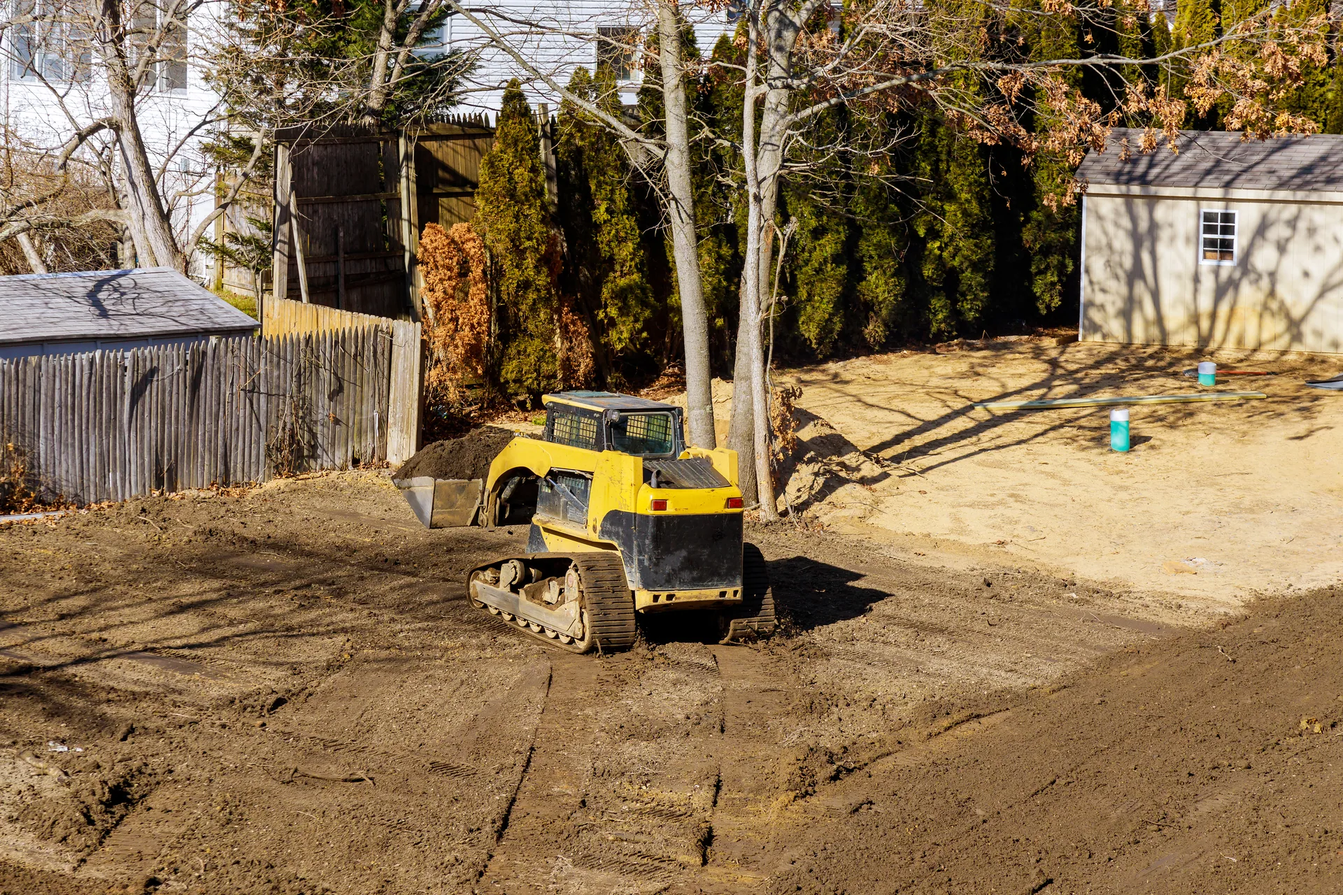 Compact track loader grading residential lot clearing