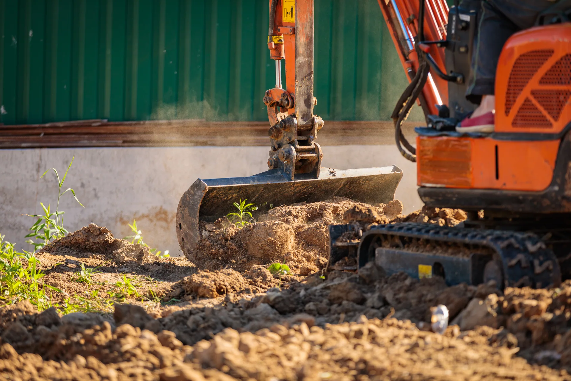 Mini excavator grading bucket leveling soil