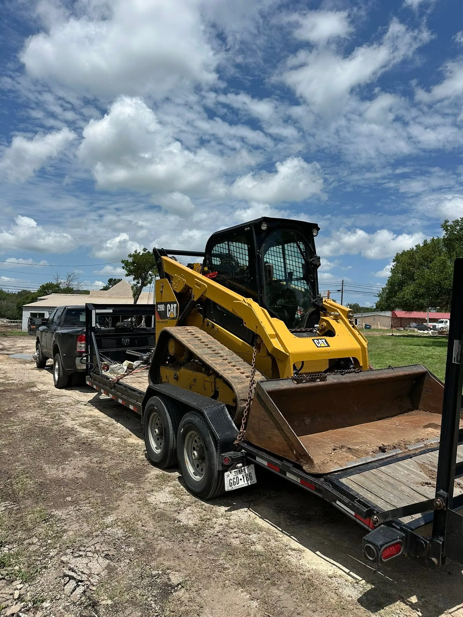 Cat compact track loader hauled on gooseneck trailer hill country