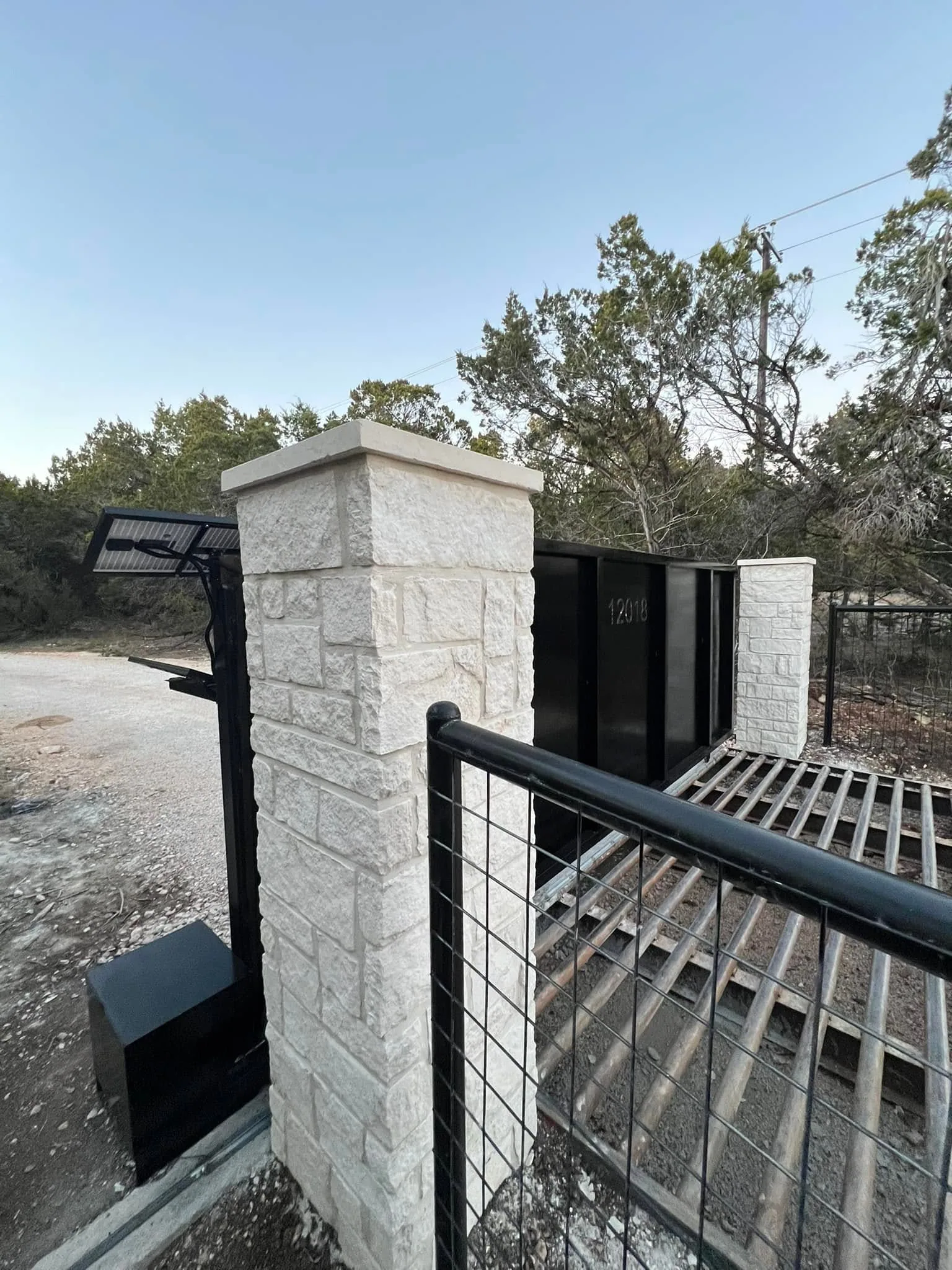 Limestone pillar cattle guard solar gate entry
