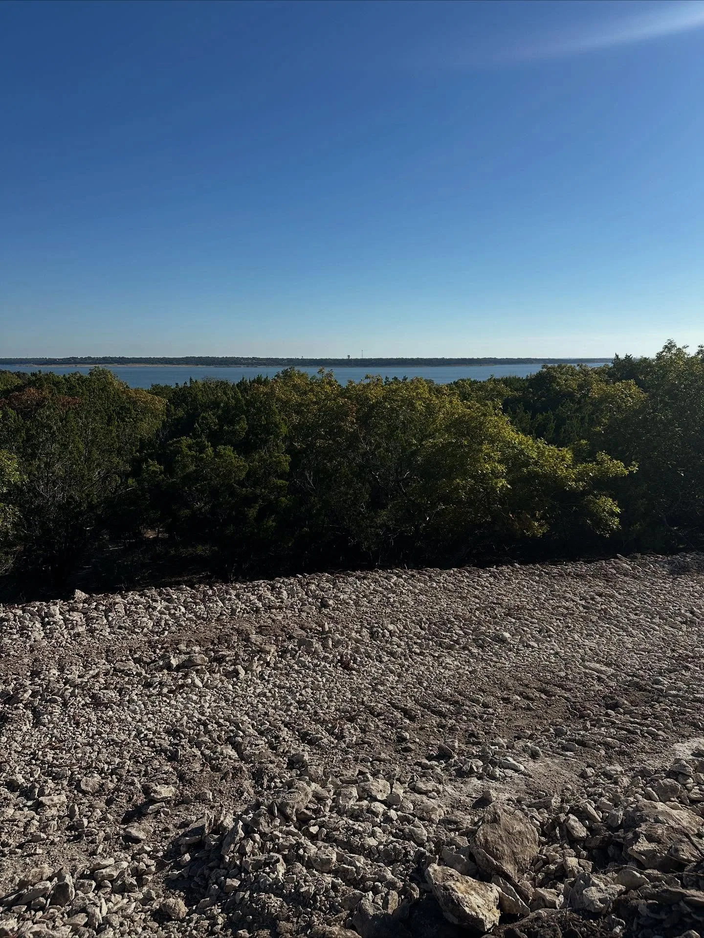 Rocky cleared hilltop pad lake view cedar grading