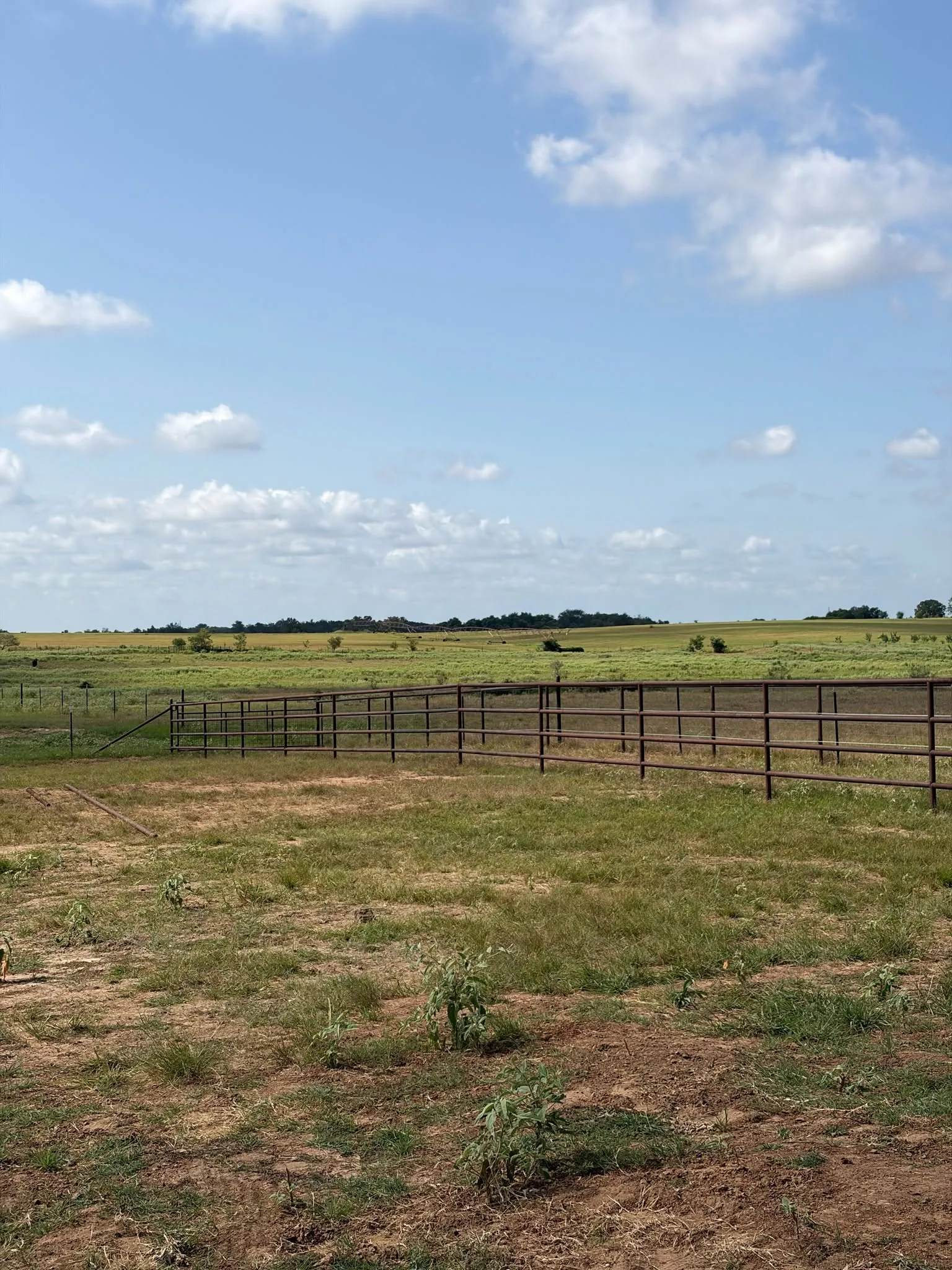 Rust brown pipe rail fence open prairie horizon