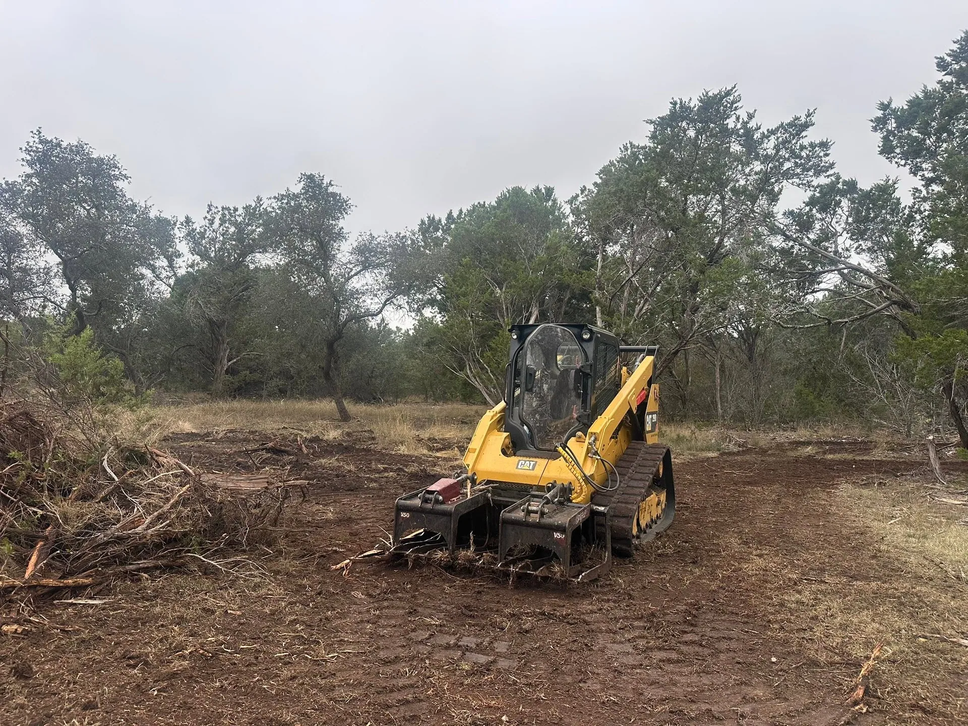 Tracked skid steer grapple brush removal lot clearing