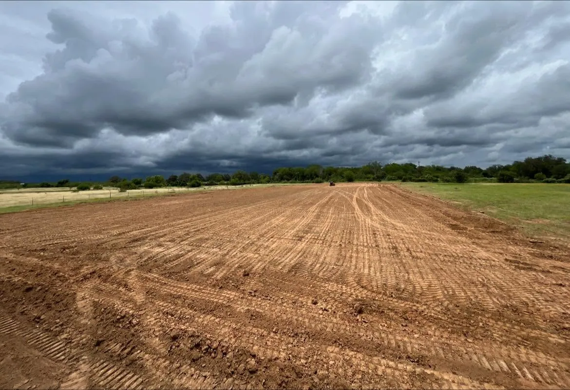 Wide graded lot storm clouds site preparation